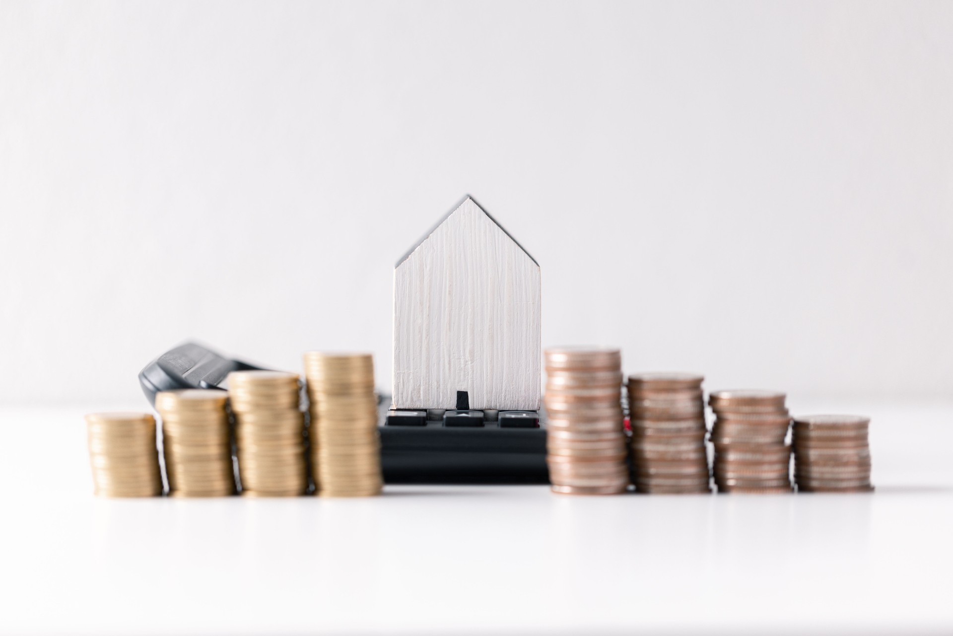House with money. Concept of finance or refinance real estate. Symbol of house stands against background of us dollars. Property investment. Home mortgage loan rate. Saving money for retirement.